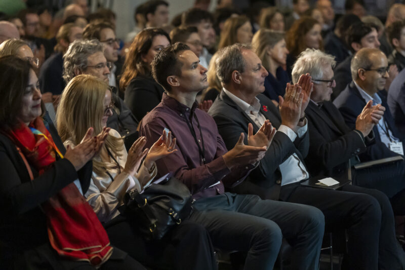 Audience clapping at a conference event.