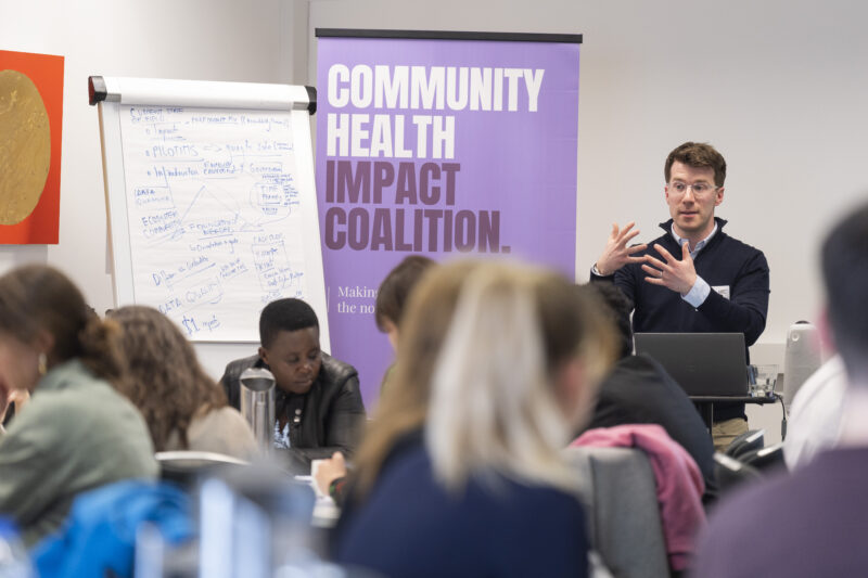 Person presenting at Community Health Impact event.