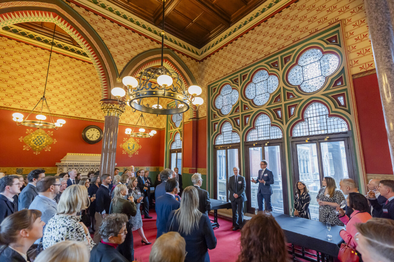 People at event in ornate historic building.