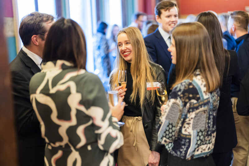 People socialising at a networking event with drinks.