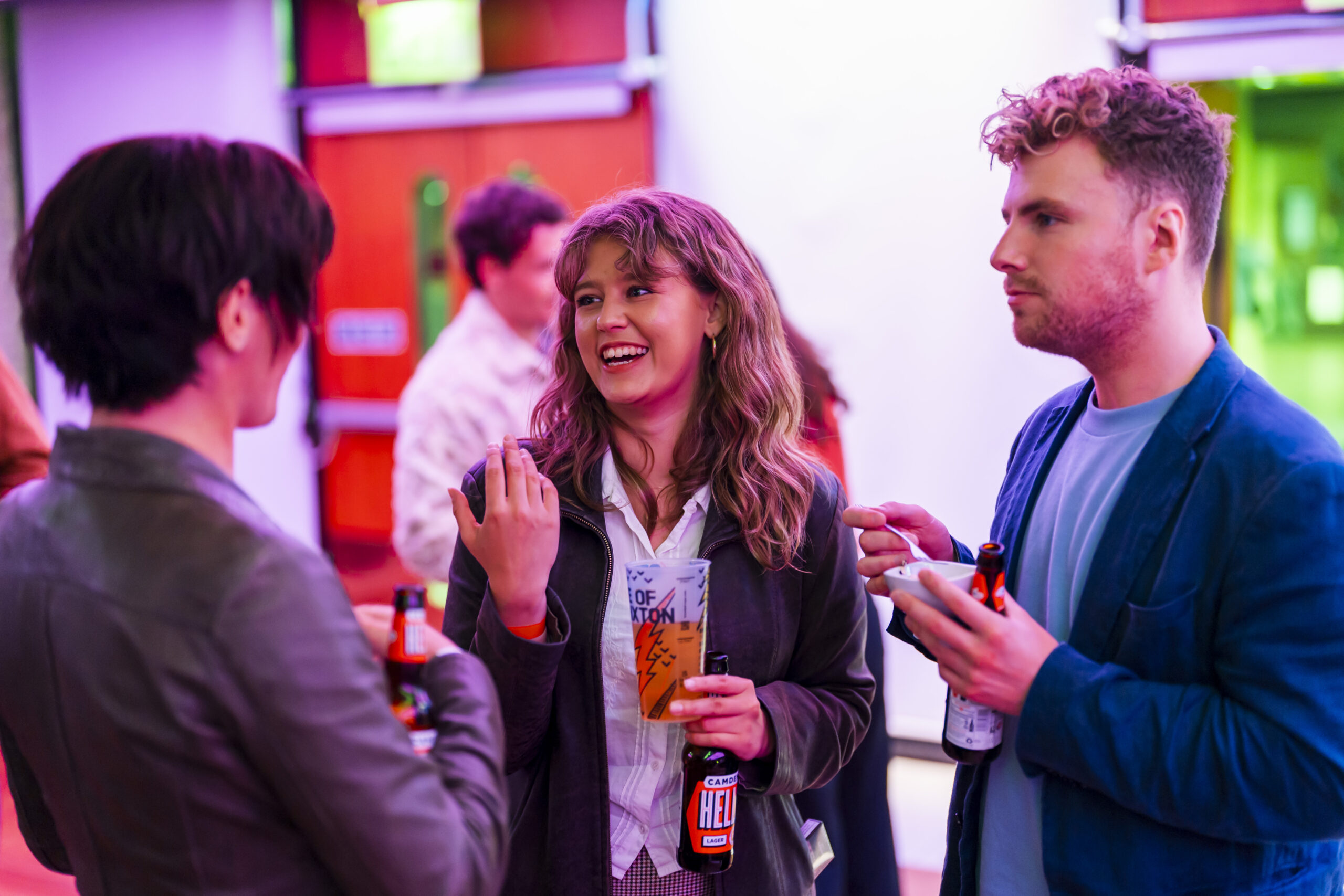 Group enjoying drinks and conversation at a party.