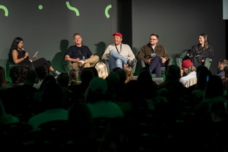 Five individuals participating in a panel discussion.