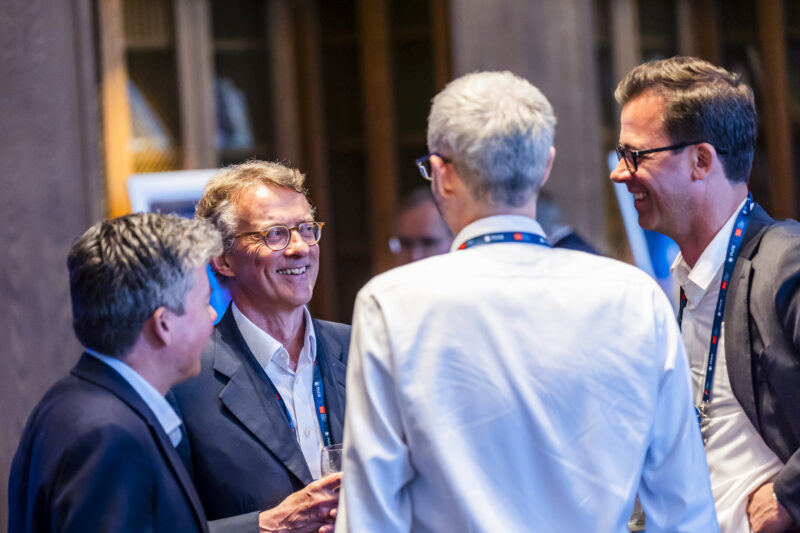 Group of professionals networking at event.