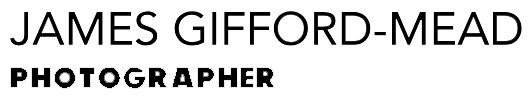 The text “JAMES GIFFORD-MEAD” is displayed in large, black, sans-serif font, with the word “PHOTOGRAPHER” in a smaller, bold, sans-serif font centred directly underneath it against a light grey background.
